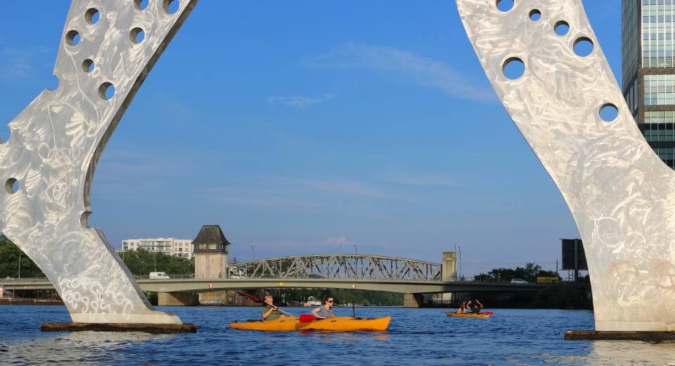 Passing under the Molecule man when kayaking in East Berlin