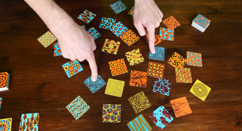 Twin It Board Game The Fast Paced Memory Game Review A set consists of two or three cards in the Twin it! board game.