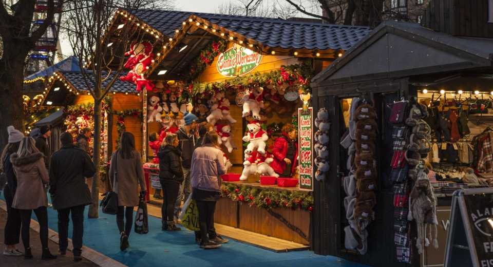 "christmas market scavenger hunt at a festively decorated toy and teddy bear stall on a busy christmas market"
